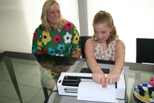 Load image into Gallery viewer, Child reading braille in Mountbatten with parent watching

